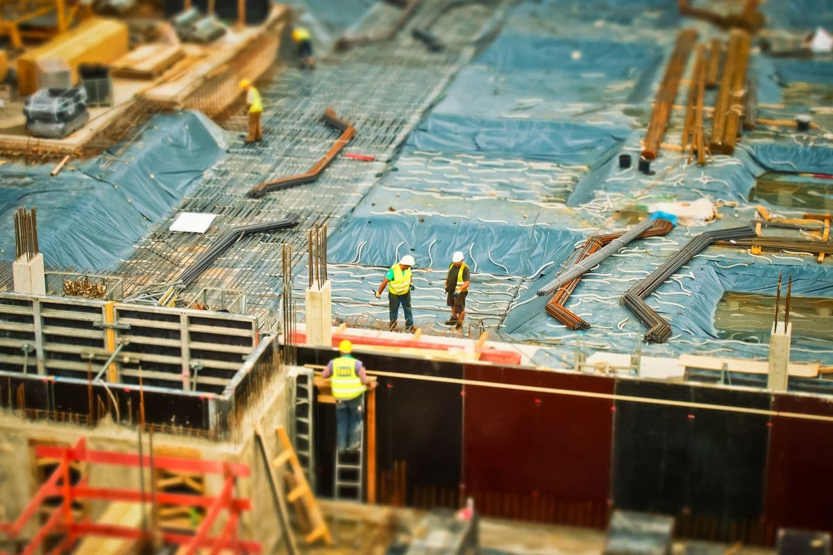 Construction supervisors inspecting site progress and quality on an active build